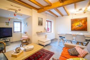 a living room with a couch and a table at Au nid d'Alsace - SPA et sauna privé in Orschwiller