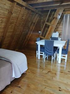 a bedroom with a table and chairs in a attic at Chalés Snow in Urubici
