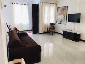 a living room with a couch and a tv at Marissa Villa in Katunayaka