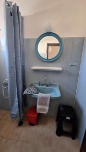 a bathroom with a blue sink and a mirror at Chryssa Bungalows in Andros +36 photos