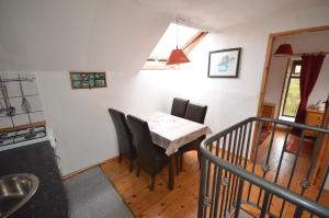 a kitchen with a table and chairs in a room at Selfcatering Apartment in Currahy Bridge