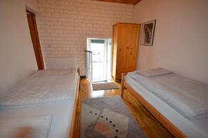a room with two beds in a room with a door at Selfcatering Apartment in Currahy Bridge
