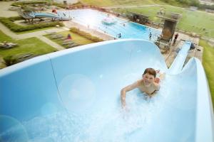 a young boy on a water slide at a water park at Cosy Cottage Vollheim in Lillehammer