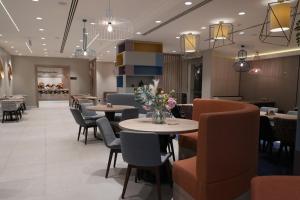 a restaurant with tables and chairs and a lobby at Hampton By Hilton Ordu in Ordu +63 photos