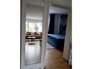 a mirror in a room with a living room at Ferienwohnung Das grüne Haus in Byhlen +20 photos
