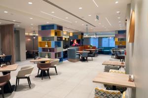a restaurant with tables and chairs and a fireplace at Hampton By Hilton Ordu in Ordu