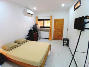 a bedroom with a bed and a television in it at Cozy Studio with Private Jacuzzi and Pool! in Saly Portudal