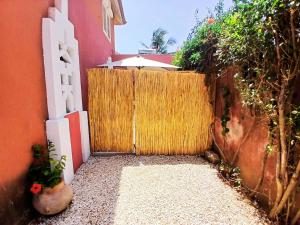an entrance to a house with a wooden gate at Cozy Studio with Private Jacuzzi and Pool! in Saly Portudal