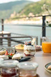 a table with food and drinks on a table at Villa Patria B&B in Brusino Arsizio
