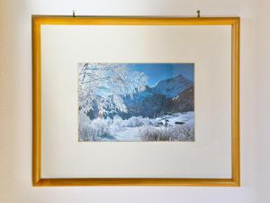 a framed picture of a snow covered mountain at Sonnenhof Seeg 14 in Seeg