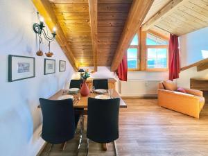 a dining room with a table and chairs at Sonnenhof Seeg 14 in Seeg