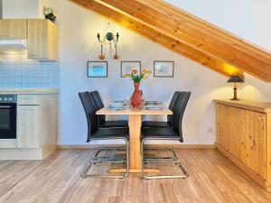a kitchen with a wooden table and black chairs at Sonnenhof Seeg 14 in Seeg +30 photos