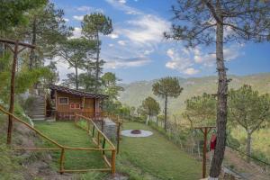 a cabin in the woods with a view of the mountains at A Kasauli Ggaon by Echor in Kasauli