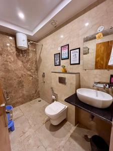 a bathroom with a white toilet and a sink at Namaste Hostel Rishikesh in Rishīkesh +31 photos