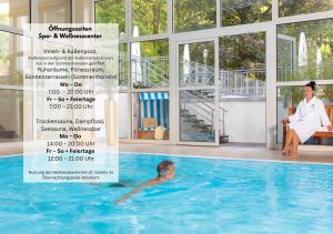 a man in a swimming pool next to a woman at INSELHOTEL Potsdam in Potsdam