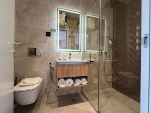 a bathroom with a shower and a sink and a toilet at Giorgio Luxury Suites in Belgrade +17 photos