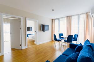 a living room with a blue couch and a table at Hotel sea view in Batumi +27 photos