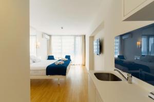 a bedroom with a bed and a sink and a bathroom at Hotel sea view in Batumi