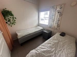 a small room with two beds and a window at Affordable, fully equipped practical housing! in Laivaniemi