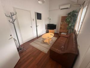 a living room with a couch and a table at Affordable, fully equipped practical housing! in Laivaniemi