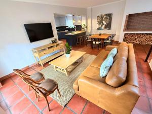 a living room with a couch and a table at Die Stal in Wellington