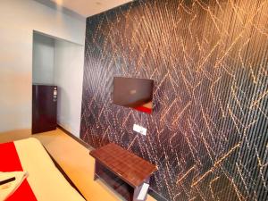 a room with a wall with a tv and a table at Jubilee Homes in Hyderabad +21 photos