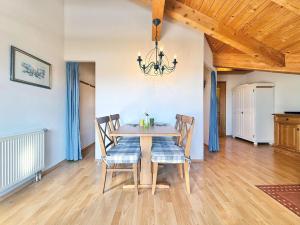 a dining room with a wooden table and chairs at Sonnenhof Seeg 17 in Seeg +20 photos