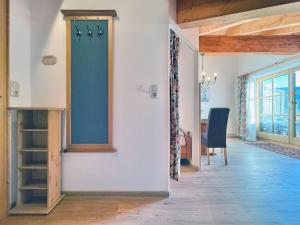 a hallway with a door and a room with a table at Sonnenhof Seeg 16 in Seeg