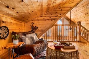 a living room with a couch and a table at Take It Easy - 5 Star Family Cabin View Hot Tub FirePit Pools Bears in Gatlinburg