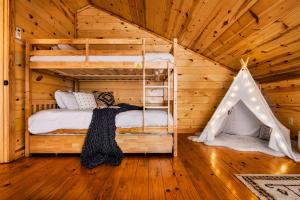 a bedroom with two bunk beds and a tent at Take It Easy - 5 Star Family Cabin View Hot Tub FirePit Pools Bears in Gatlinburg +49 photos
