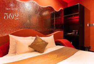 a hotel room with a bed with a gold sign on it at TROY HOTEL - Bà Rịa in Ấp Long Kiên I