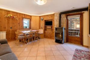 a kitchen and dining room with a table and a stove at Chalet di Mont in Valfurva