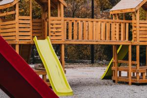 a playground with a slide and a play structure at Wood Hills Hotel & Resort in Mayrūbā