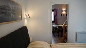 a bedroom with a bed and a dining room with a table at Baita Valmalenco - Casa con sauna panoramica, 5 minuti da Chiesa Valmalenco in Torre di Santa Maria