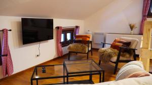 a living room with a flat screen tv on a wall at Baita Valmalenco - Casa con sauna panoramica, 5 minuti da Chiesa Valmalenco in Torre di Santa Maria