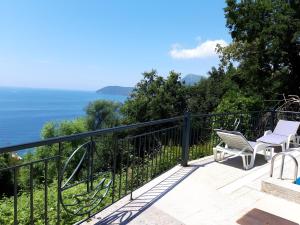 a balcony with two chairs and a view of the ocean at Apartment Sofia in Sutomore