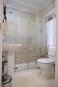 a bathroom with a shower and a toilet and a sink at Hotel Gabriel y Galán in Salamanca +13 photos
