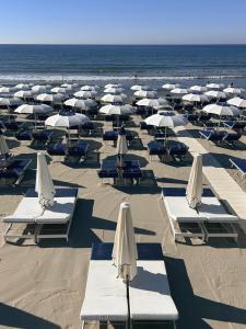 a bunch of chairs and umbrellas on a beach at Grecale - Villa Marina in Marina di Andora +12 photos