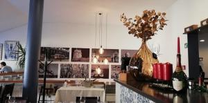 a kitchen with a counter with a vase with flowers on it at Lisboa II Hotel Restaurant in Luxembourg