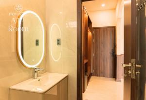 a bathroom with a sink and a mirror at TROY HOTEL - Bà Rịa in Ấp Long Kiên I +25 photos