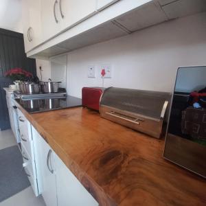 a kitchen with a counter top with a toaster oven at 200 on Genazzano in Densainagar