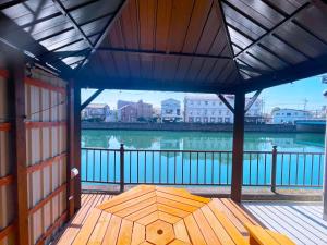 a screened in porch with a view of a body of water at ゲストハウス 清水銀座 in Shizuoka