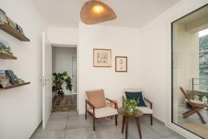 a living room with two chairs and a table at Villa Patria B&B in Brusino Arsizio +99 photos