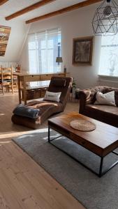 a living room with two couches and a coffee table at Ferienwohnung Lerchi's Ankerplatz in Barßel