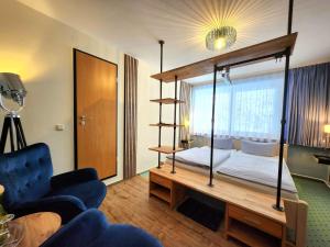 a hotel room with a bed and a living room at Pension Am Nationalpark in Stadt Wehlen