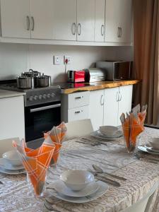 a kitchen with a table with plates and utensils at 200 on Genazzano in Densainagar