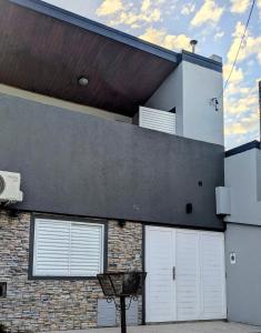 a building with four white garage doors on it at San Juan Santo Tome in Santo Tomé