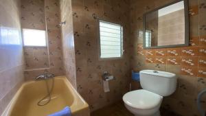 a bathroom with a toilet and a sink and a tub at El Chorro Atico in Calera +35 photos