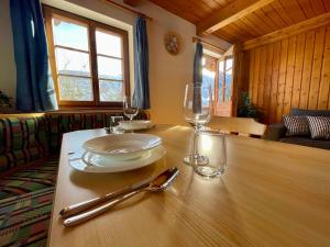 a table with two glasses and a plate and spoon at Mantlerhof in Virgen