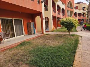 a sidewalk next to a building with a tree next to it at Ground floor Garden & Pool & Beach Studio in Sharm El Sheikh